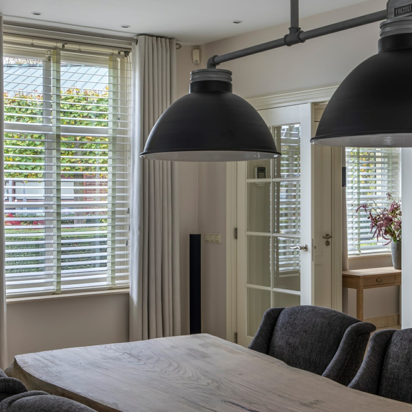 Witte houten jaloezieën in de eetkamer